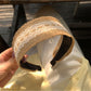 Top view of soft straw lace headband showing intricate weaving and lace design