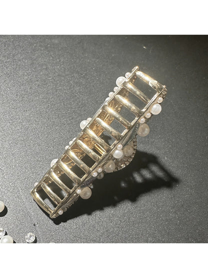 Side view of Beau artistic hair clip attached to dark brown hair
