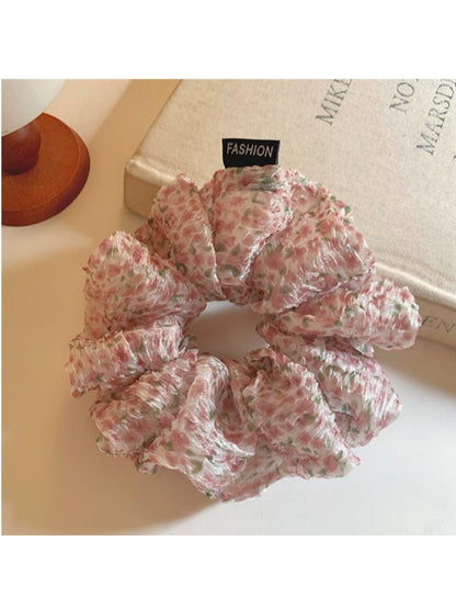 Pink floral tulle scrunchie wrapped around a ponytail