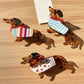 Beau cute dachshund shaped claw clip in brown and black colors on white background