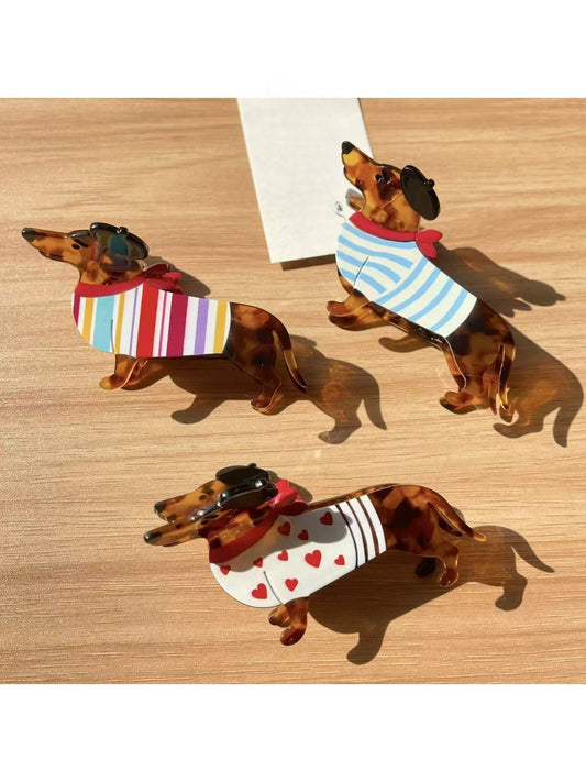 Beau cute dachshund shaped claw clip in brown and black colors on white background