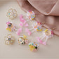 Pair of small flower-shaped earrings with intricate beadwork on a white background