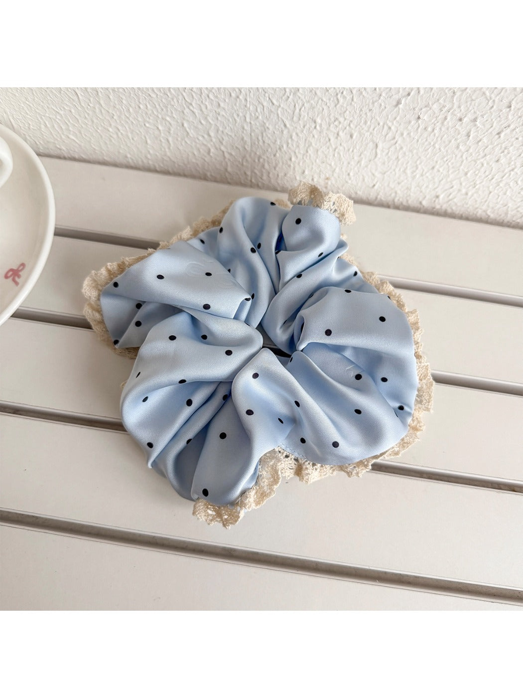 Gifty sweet polka dot lace trim scrunchie styled in a casual hair bun