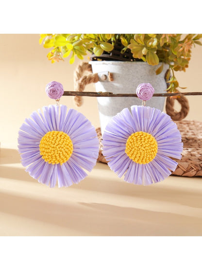 Top view of the sunflower earrings highlighting the detailed raffia weaving