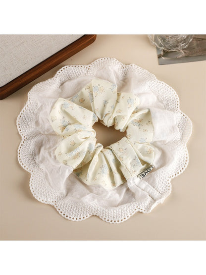 Gifty scrunchie wrapped around a ponytail, showcasing vibrant patchwork design