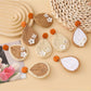 Earedge raffia teardrop earrings hanging on a wooden display stand