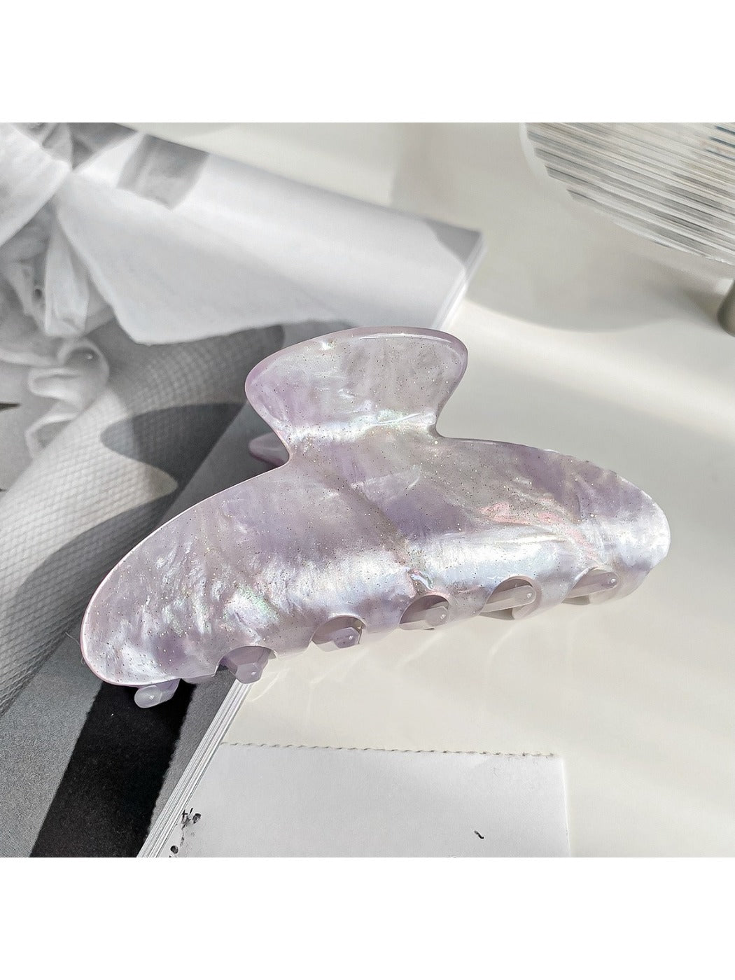 Top view of Beau claw clip emphasizing pearlescent color and shape