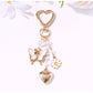 Butterfly heart keychain displayed on a reflective surface highlighting its colors