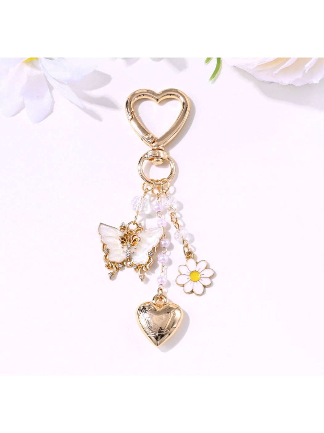 Butterfly heart keychain displayed on a reflective surface highlighting its colors