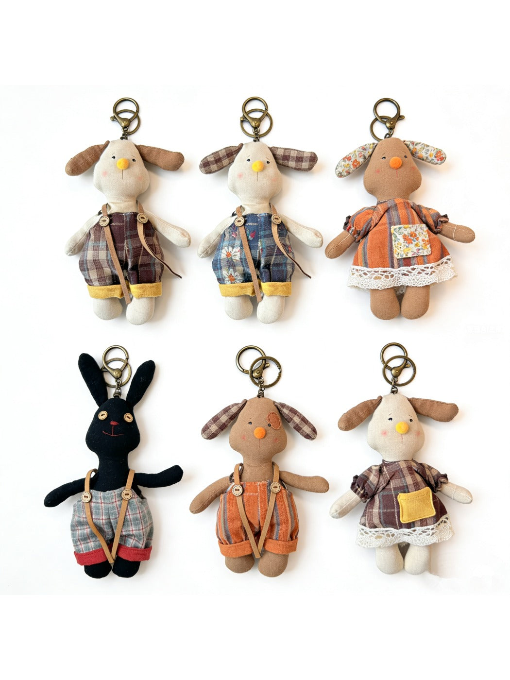 Back view of the fabric puppy keychain displaying plain fabric and keyring attachment