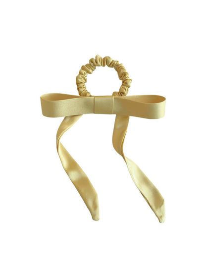 Gifty satin yellow ribbon bow scrunchie styled in blonde hair ponytail
