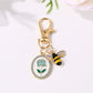 Alloy rose flower print keychain displayed on a white background