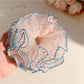 Close-up of Gifty Hazy Elegant Mesh Scrunchie in soft pastel color on white background