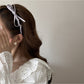 Close-up of pink bow accented headband showing fabric texture