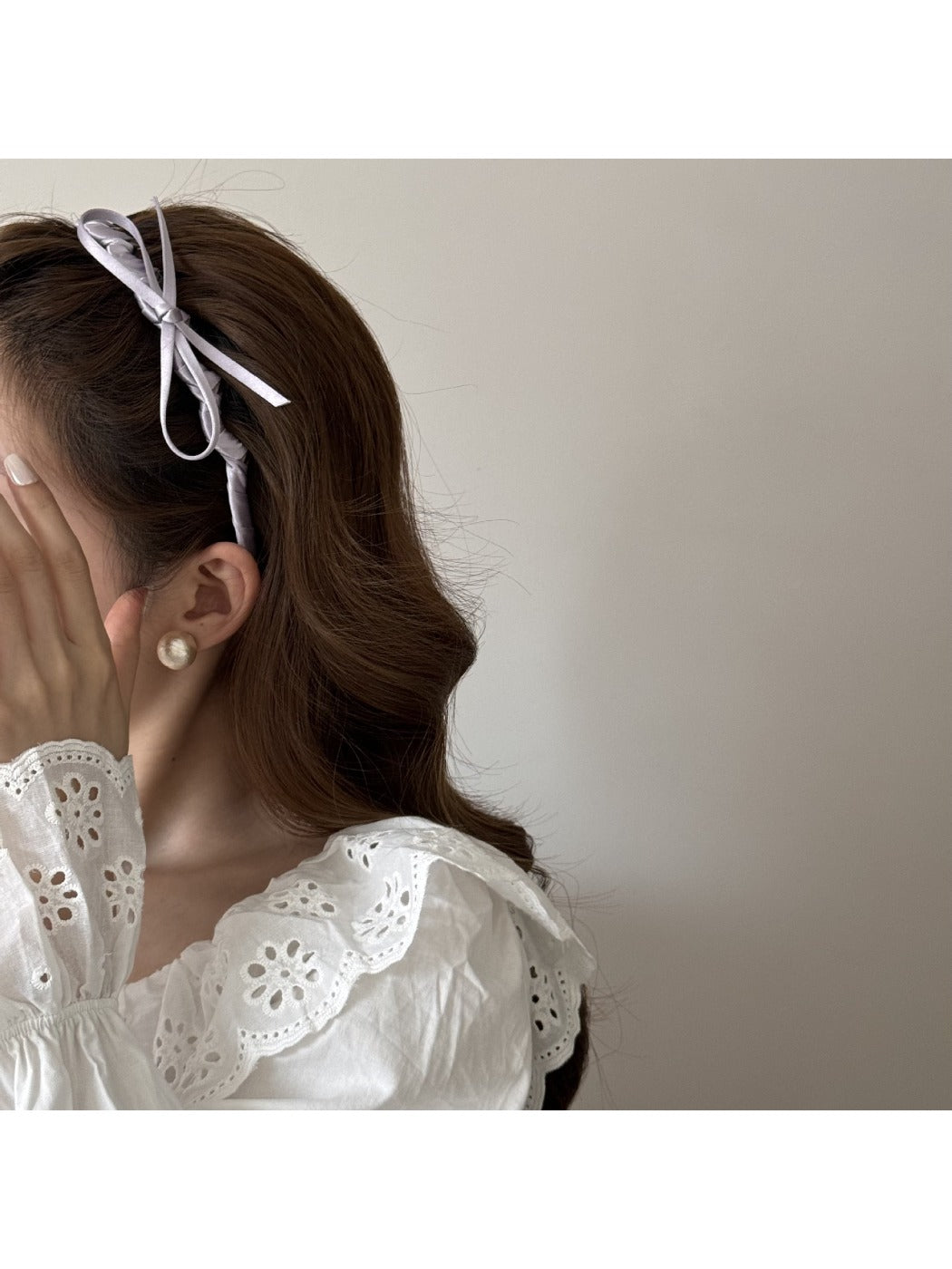 Close-up of pink bow accented headband showing fabric texture