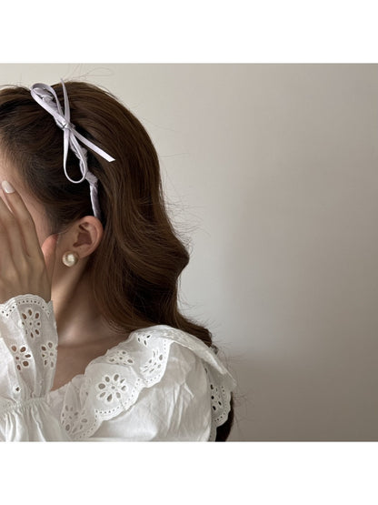Close-up of pink bow accented headband showing fabric texture