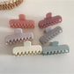 Beau colorful rectangular hair clip in pastel pink on white background
