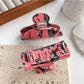 Side view of Beau hair claw clip highlighting curved teeth and crow pattern