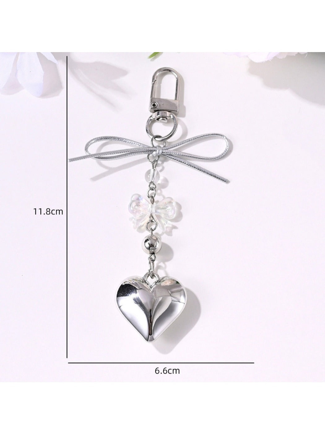 Close-up of Keypus bow keychain showing detailed star and heart shapes