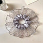 Gray mesh polka dot scrunchie displayed flat showing texture and pattern