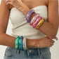 Close-up of Lovra bangle bracelet showing multicolored irregular shapes