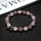 Lovra bracelet with heart pendant displayed on a wooden surface
