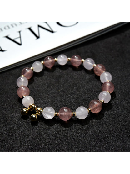 Lovra bracelet with heart pendant displayed on a wooden surface
