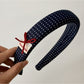 Blue scrunchie stretched to show elasticity and fabric quality