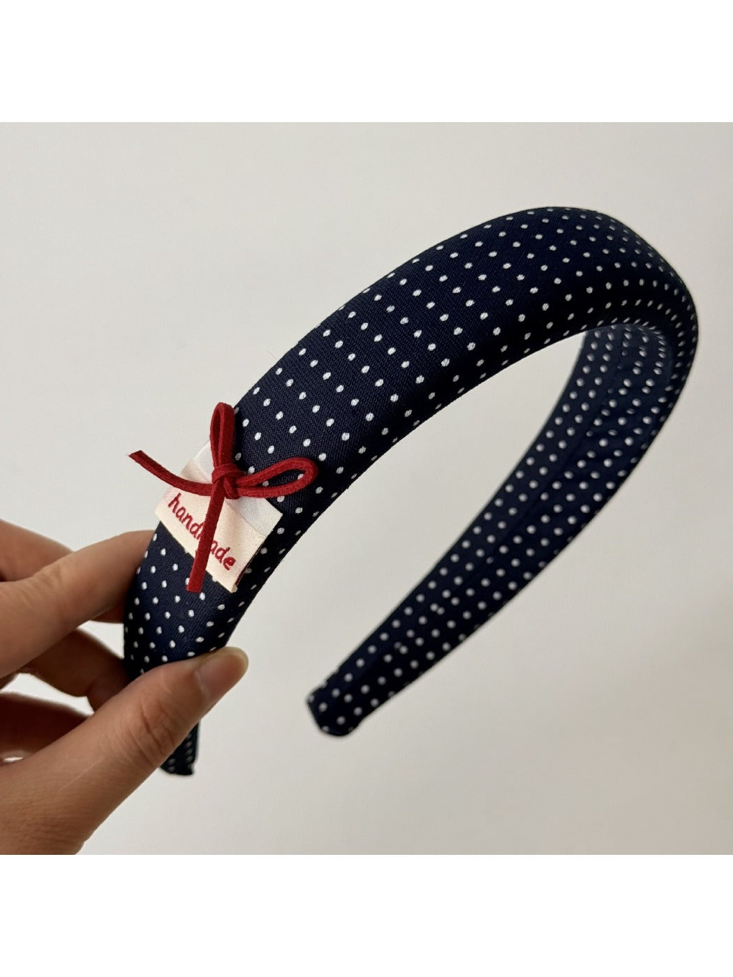 Blue scrunchie stretched to show elasticity and fabric quality