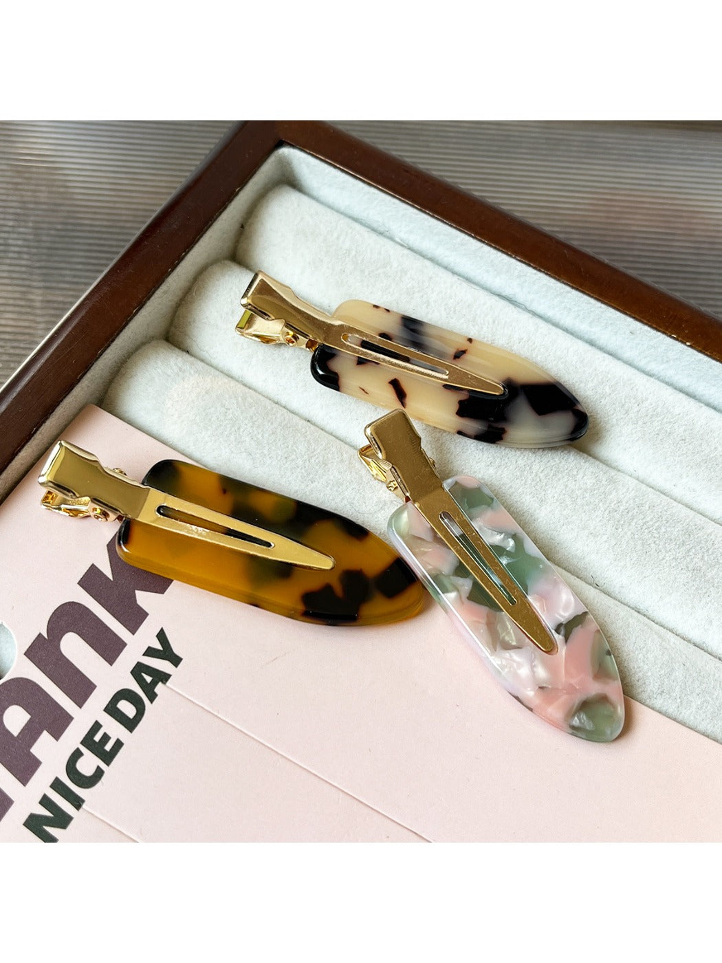 Beau acetate invisible hair clip held in hand to show size and transparency