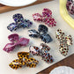 Beau leopard print bow-shaped hair claw clip on white background