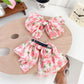 Close-up of red floral bow scrunchie fabric texture