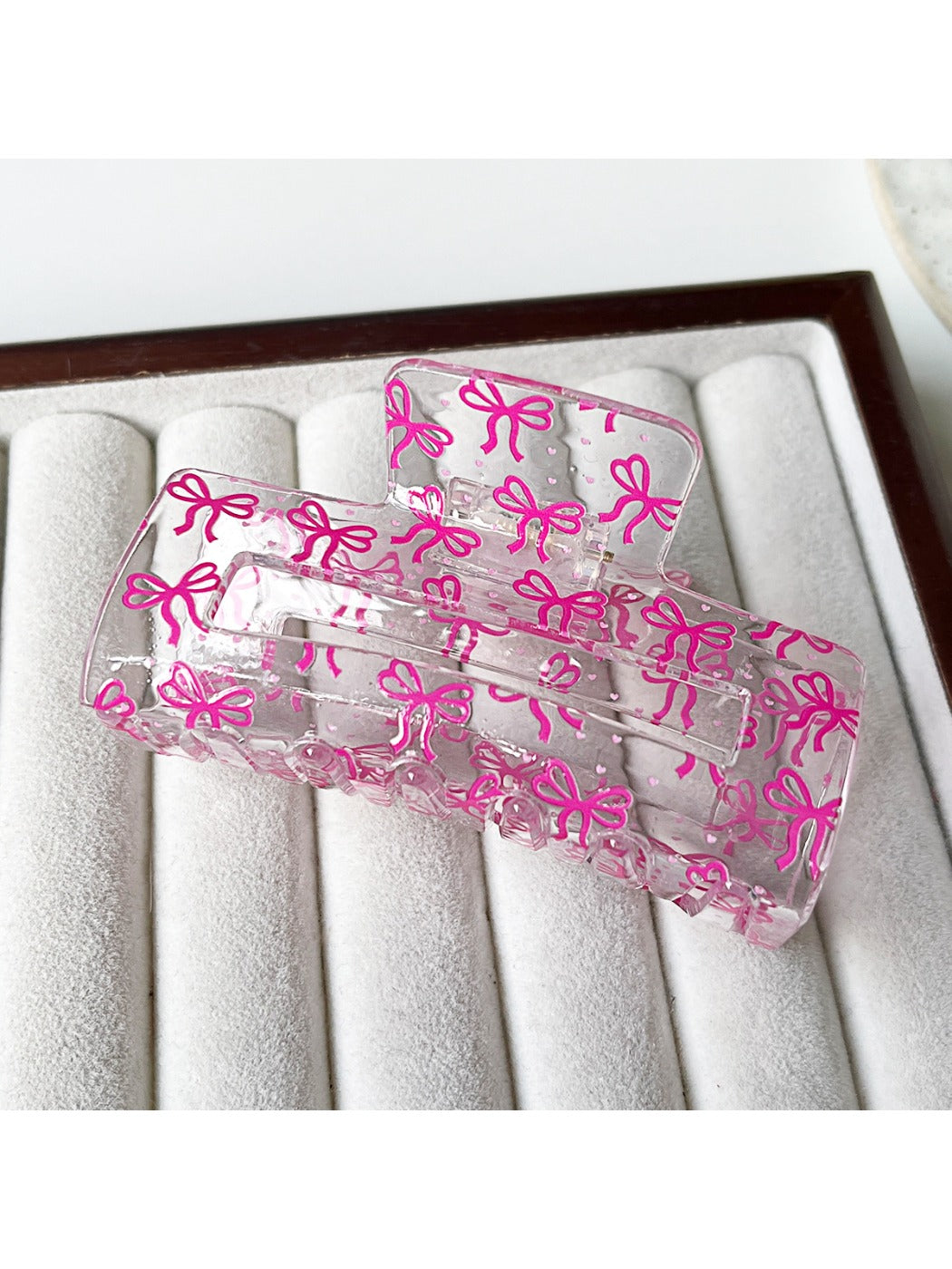 Clear acetate claw clip displayed on a neutral background