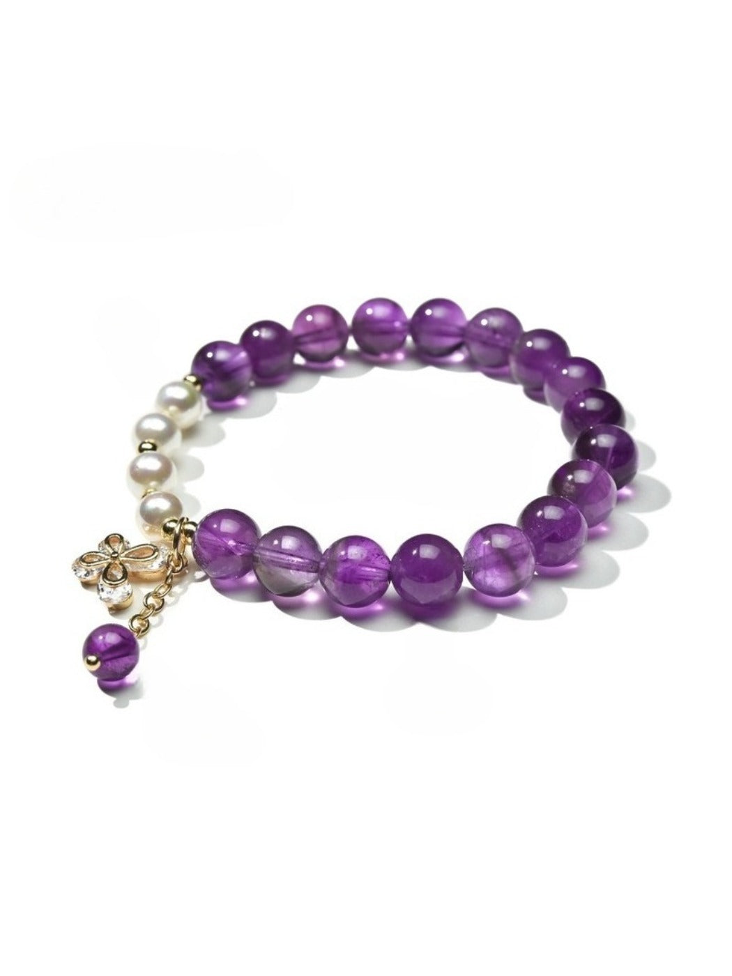 Detailed shot of butterfly charm on Lovra vintage beaded bracelet with multicolored beads