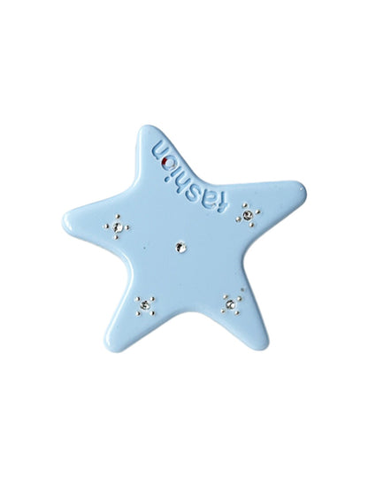 Beau acetate star hair clip held in hand showing size