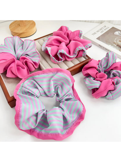 Close-up of magenta and pink striped scrunchie fabric texture