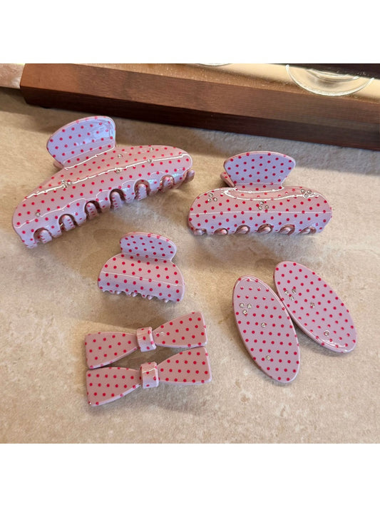 Close-up of Beau pink polka dot claw clip with white dots on a light pink background
