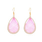 Pair of Earedge Cord Woven Teardrop Earrings on a wooden surface with soft lighting
