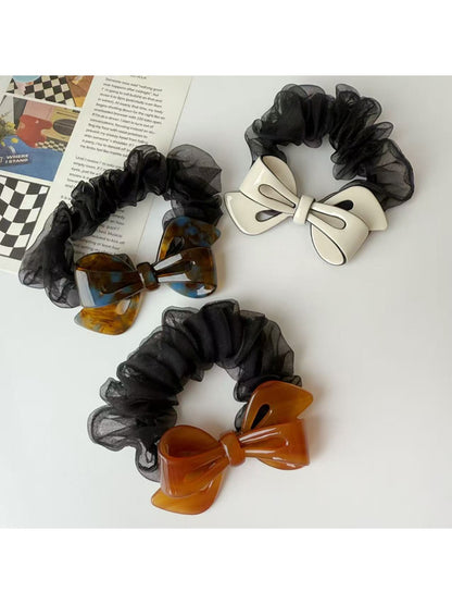 Gifty mesh bow acetate scrunchie displayed on a white background