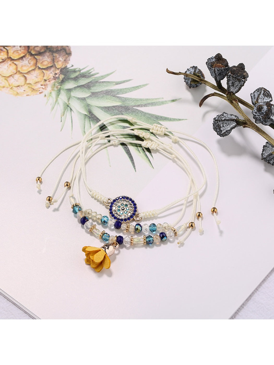Side view of Lovra small bead tassel alloy bracelet highlighting alloy chain and tassel