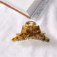 Beau acetate bow shaped claw clip shown with natural light highlighting color