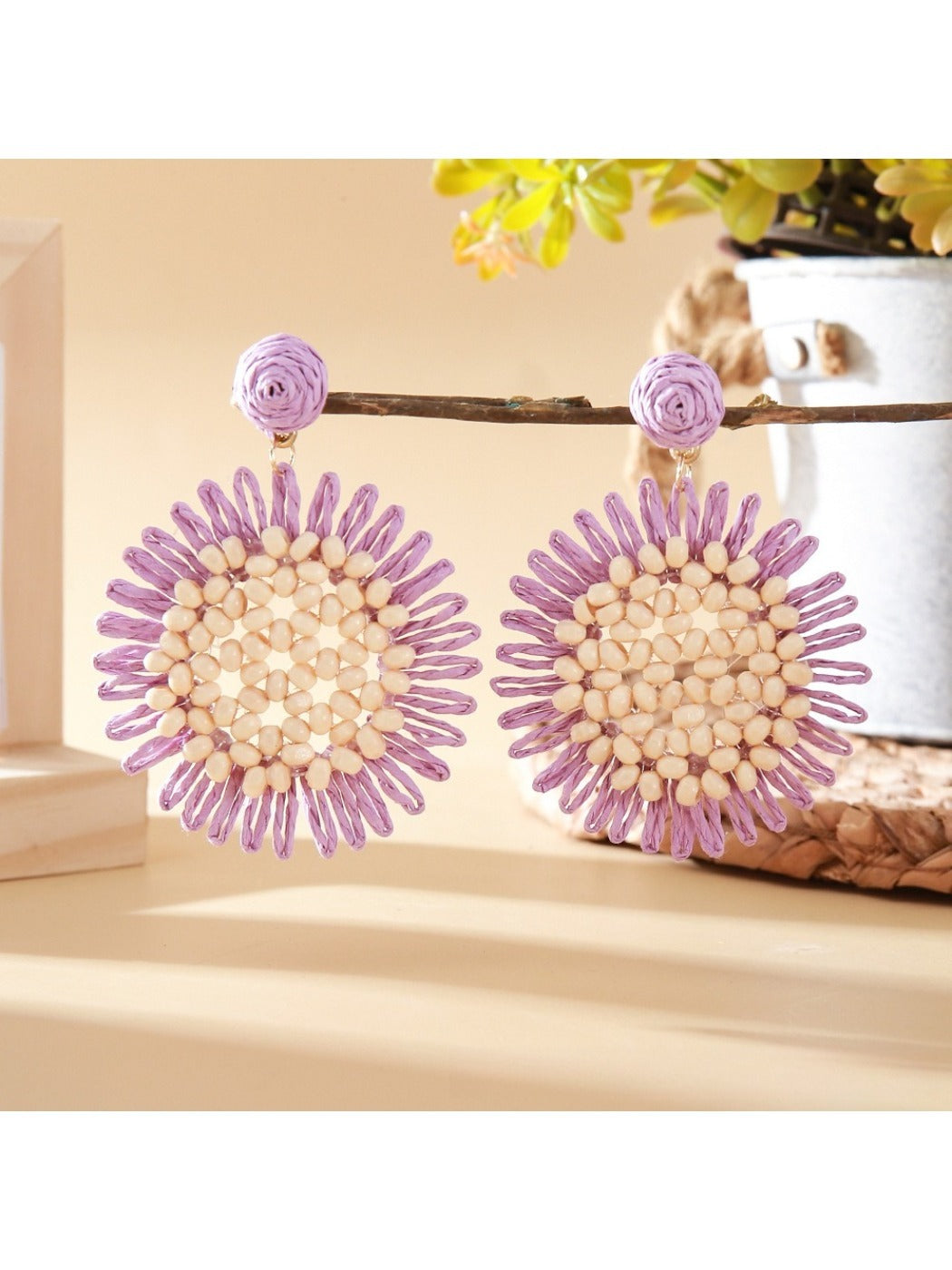 Sunflower drop earrings placed on a wooden surface with natural lighting