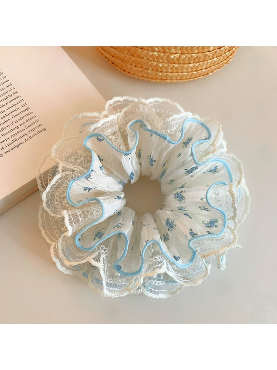 Gifty floral ruffled scrunchie styled on a wrist showing soft fabric texture and floral pattern