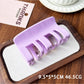 Beau plastic square claw clip resting on textured fabric background