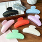 Beau stylish half round hair clip in matte black on white background