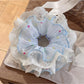 Side view of Gifty polka dot scrunchie highlighting fabric texture and pattern
