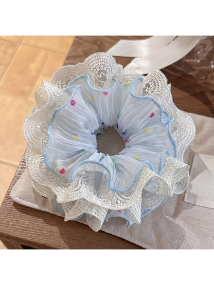 Side view of Gifty polka dot scrunchie highlighting fabric texture and pattern