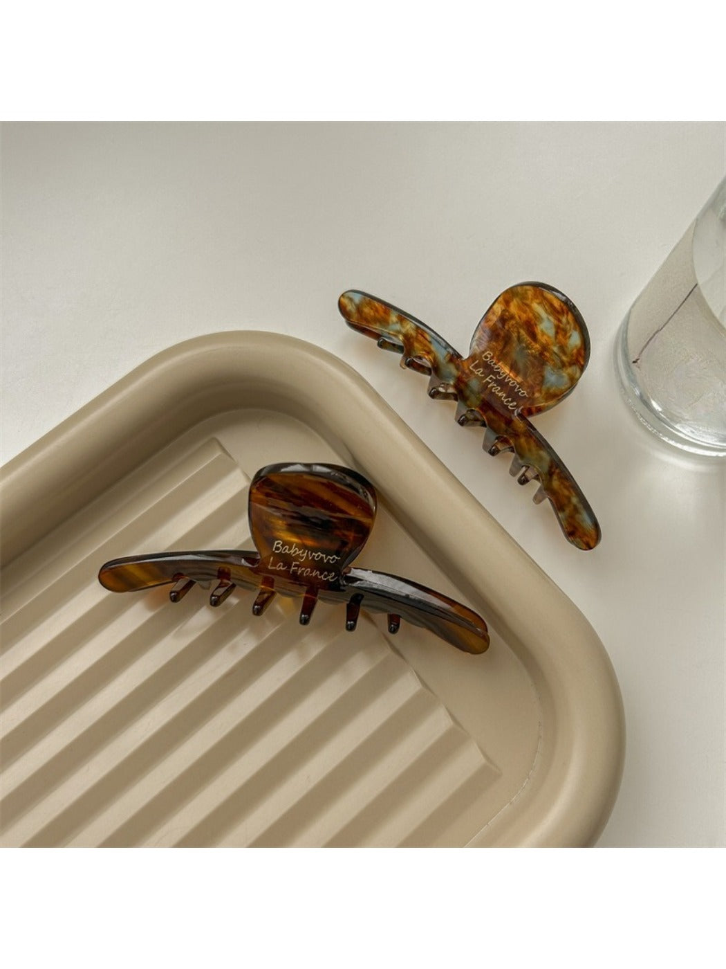 Close-up of Beau brown acetate claw clip highlighting glossy finish and teeth