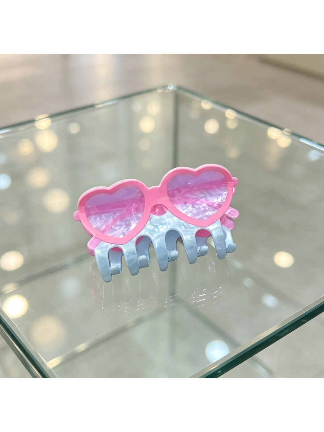 Beau acrylic glasses-shaped claw clip displayed on a wooden surface