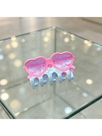 Beau acrylic glasses-shaped claw clip displayed on a wooden surface